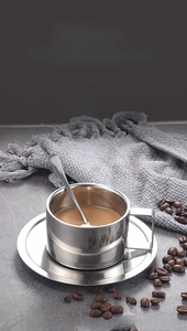 Close-up of 304 stainless steel double-layer coffee cup with matching saucer and spoon