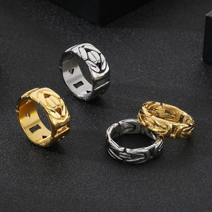 Detailed view of gold and silver stainless steel rings with woven chain texture