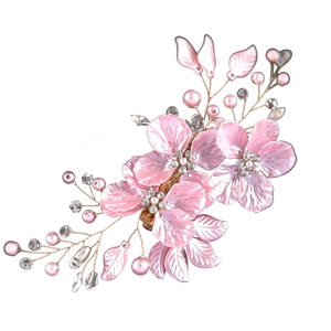 Macro detail of pink shell petals hair clip with pearls and crystal beads on gold wire