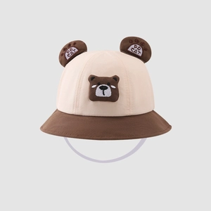 Detailed macro view of a cute kids cartoon bear bucket hat with 3D ears and embroidery