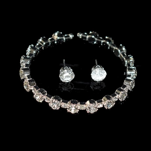 Detailed close-up of sparkling crystal necklace and matching round studs jewelry set
