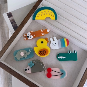 Cute acetate animal and fruit hair clips set in a velvet jewelry display tray