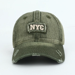 Detail of army green washed NYC baseball cap featuring vintage distressing and embroidery