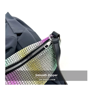 Close-up of smooth silver zipper and gradient rhinestones on fashion shoulder bag