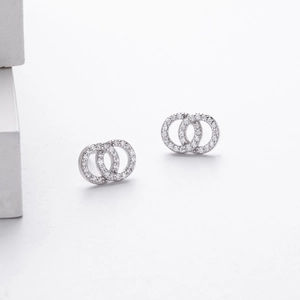 Macro shot of silver sterling intertwined double hoop earrings with pavé set crystals
