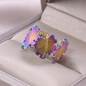 Macro shot of rainbow-colored leaf ring in a beige jewelry gift box setting