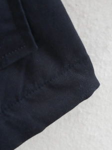 Detailed close-up of double-stitched seams and smooth fabric texture on winter jacket