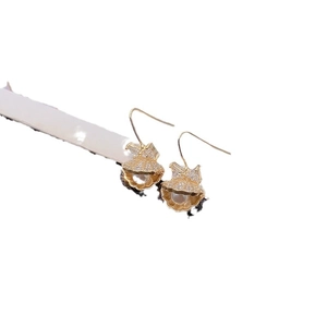 Elegant gold shell earrings with white pearl and zircon accents on white background