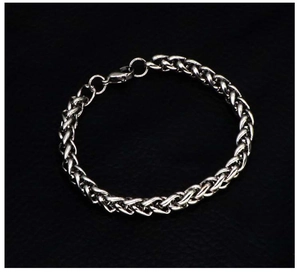 Detailed view of silver stainless steel thick woven chain bracelet with lobster clasp