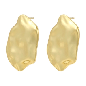Macro detail of 18K gold plated earrings featuring a textured lava surface and water ripple