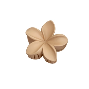 Matte beige plumeria flower hair claw clip with elegant five-petal design on white background