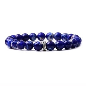 Macro shot of dark blue marble texture beads with a silver metal divider on a beaded bracelet