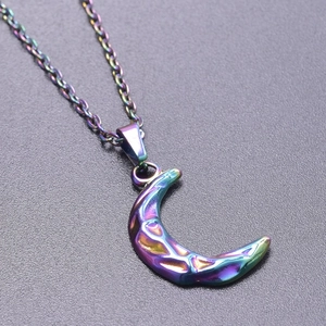Detail of crescent moon necklace with iridescent finish and hammered texture surface