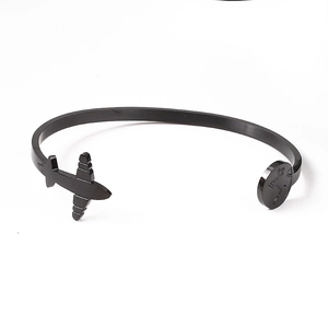 Detail of matte black airplane and world map engraving on stainless steel cuff bracelet