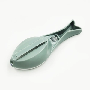 Green fish-shaped manual fish scale scraper with cover for efficient kitchen use