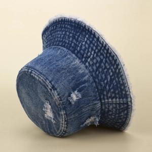 Close-up of vintage distressed denim bucket hat with ripped holes and frayed edges