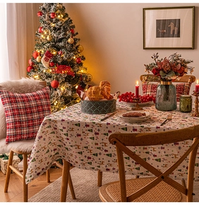 Christmas theme tablecloth and red checkered pillow in a cozy festive holiday setting