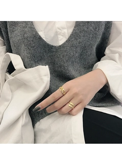 Close-up of gold S925 sterling silver rings with irregular textures on a female hand