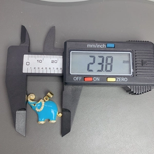 Detail showing blue elephant pendant measurement of 23.8 mm with a digital caliper