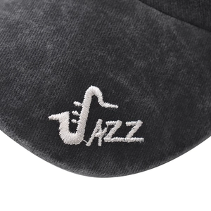 Detailed view of Jazz saxophone embroidery on washed dark grey cotton baseball cap