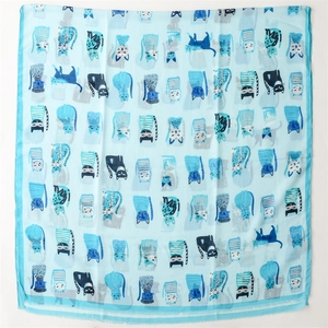 Detail of light blue silk scarf featuring various cute cartoon cat patterns and textures