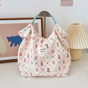 Detail of embossed bubble fabric tote bag with cute animal patterns and braided rope handle