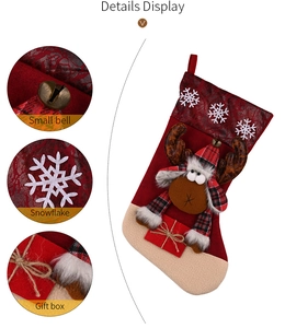 Detail view of large Christmas stocking with reindeer plush, snowflake patterns and small bell