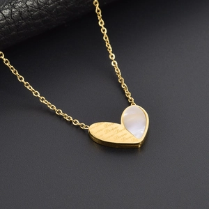 Luxury gold heart necklace with engraved Love text and white shell inlay on dark background