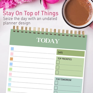 Detail view of the gray-green daily planner with top priorities and tomorrow sections