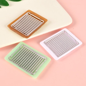 Three miniature dollhouse BBQ grill pans in brown, white, and mint green colors