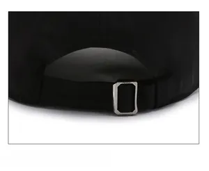 Rear view detail of black baseball cap with adjustable metal buckle and cotton texture