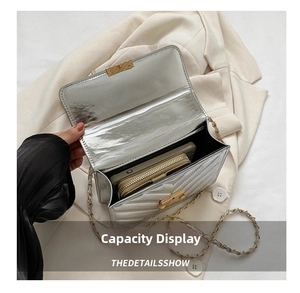 Detail view of silver quilted shoulder bag interior showing capacity for phone and wallet