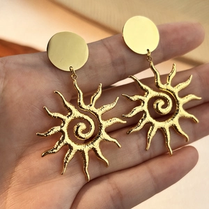 Fashionable 18k gold plated stainless steel sunflower earrings worn by a model