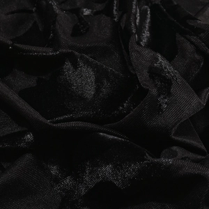 Close-up of black velvet and mesh fabric showing elegant texture and soft sheen