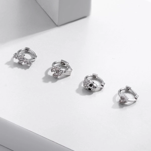 Silver earring set with cross, paw, skull, and heart charms inlaid with sparkling zircons