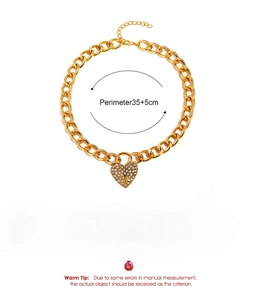 Detailed view of chunky gold chain necklace featuring a crystal paved heart lock pendant