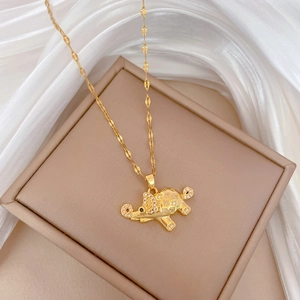 Detail of gold elephant pendant with full rhinestones on flat link titanium chain