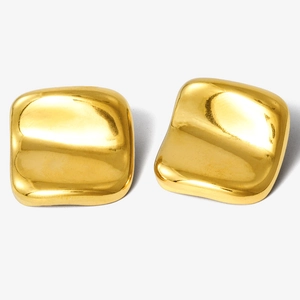 Macro detail of gold irregular square earrings with a polished mirror finish on white