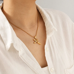 Detail van feeënhanger ketting met zirkoonvleugels op een model in wit overhemd