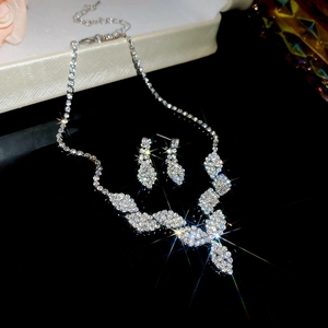 Detailed view of silver water drop tassel jewelry set with sparkling rhinestones on dark surface