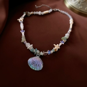 Macro detail of Bohemian shell necklace with starfish beads and iridescent shell pendant