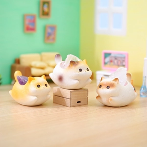 Three cute resin cats carrying crystals in a cozy miniature dollhouse setting decoration