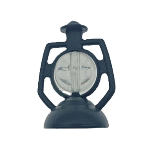 Detailed close-up of a miniature black plastic vintage lantern with clear spherical lens