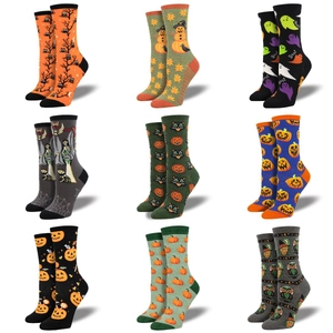 Nine pairs of Halloween themed crew socks featuring pumpkin and ghost patterns