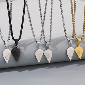 Detailed view of heart pendants with fingerprint patterns in silver, black, and gold tones