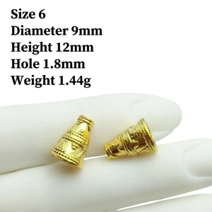 Close-up of golden cone bead with wave texture measuring 9x12mm for jewelry making