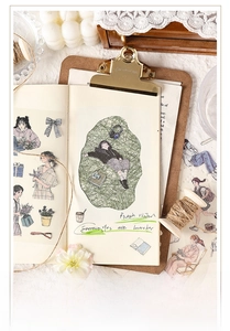 Macro view of vintage style scrapbook stickers featuring characters and daily life elements
