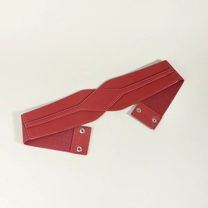 Detail of red elastic waist belt with PU leather拼接 and silver metal snap button closure