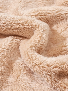 Close-up of thick camel double-sided fleece fabric showing soft warm texture