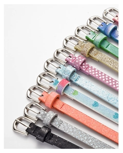Close-up of sparkling sequin belts in various vibrant colors with silver metal buckles